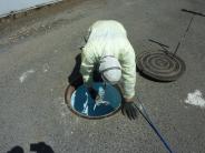 Contractor working to rehabilitate a sewer manhole 